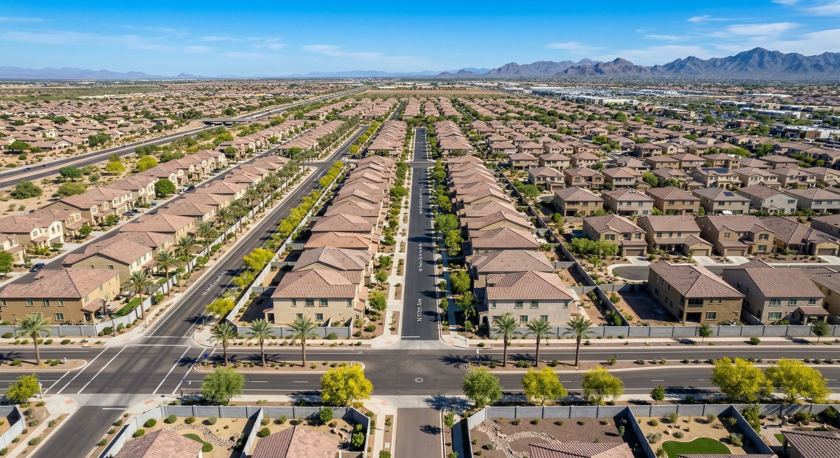 Arizona neighborhood aerial view showing Avondale West Valley subdivision homes with desert landscaping block walls and clear blue sky