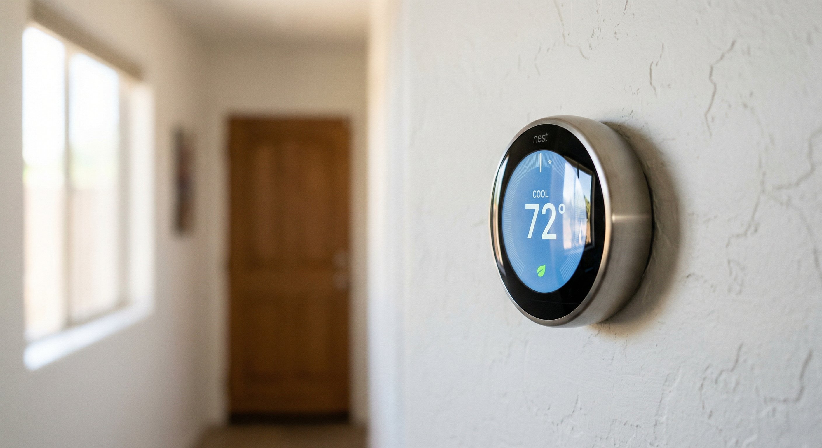 Google Nest Learning Thermostat on white wall in Arizona home